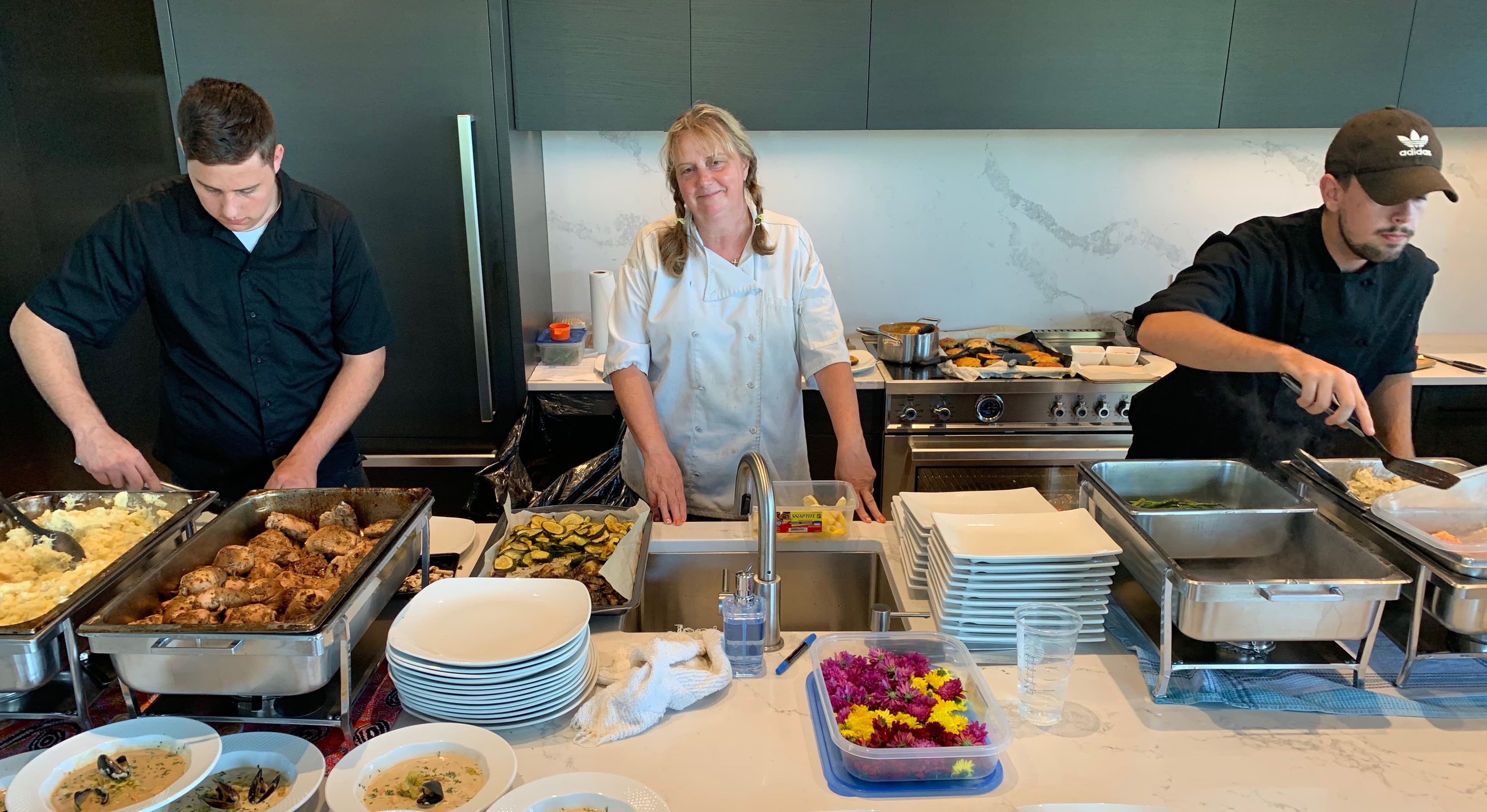 Lisa with her sons Harrison and Jeremy plating a buffet service at an event in 2016